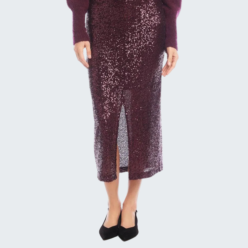 A model wearing a dark burgundy sequined midi skirt with a front slit, paired with a matching burgundy sweater and black heels, against a white background.