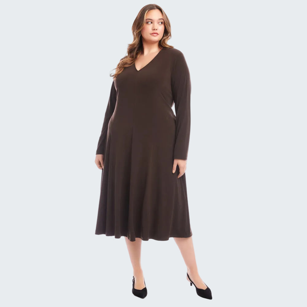 A woman modeling a dark brown long-sleeve V-neck midi dress with a flared skirt, paired with black heels, against a solid white studio background.