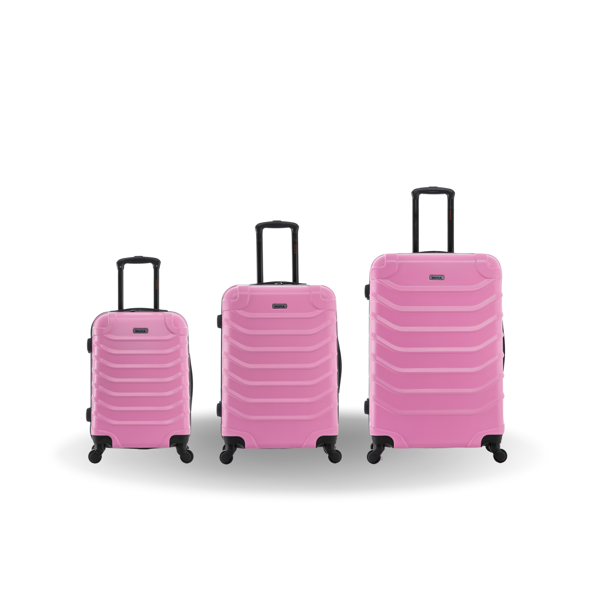 Three pink suitcases of different sizes on a white background