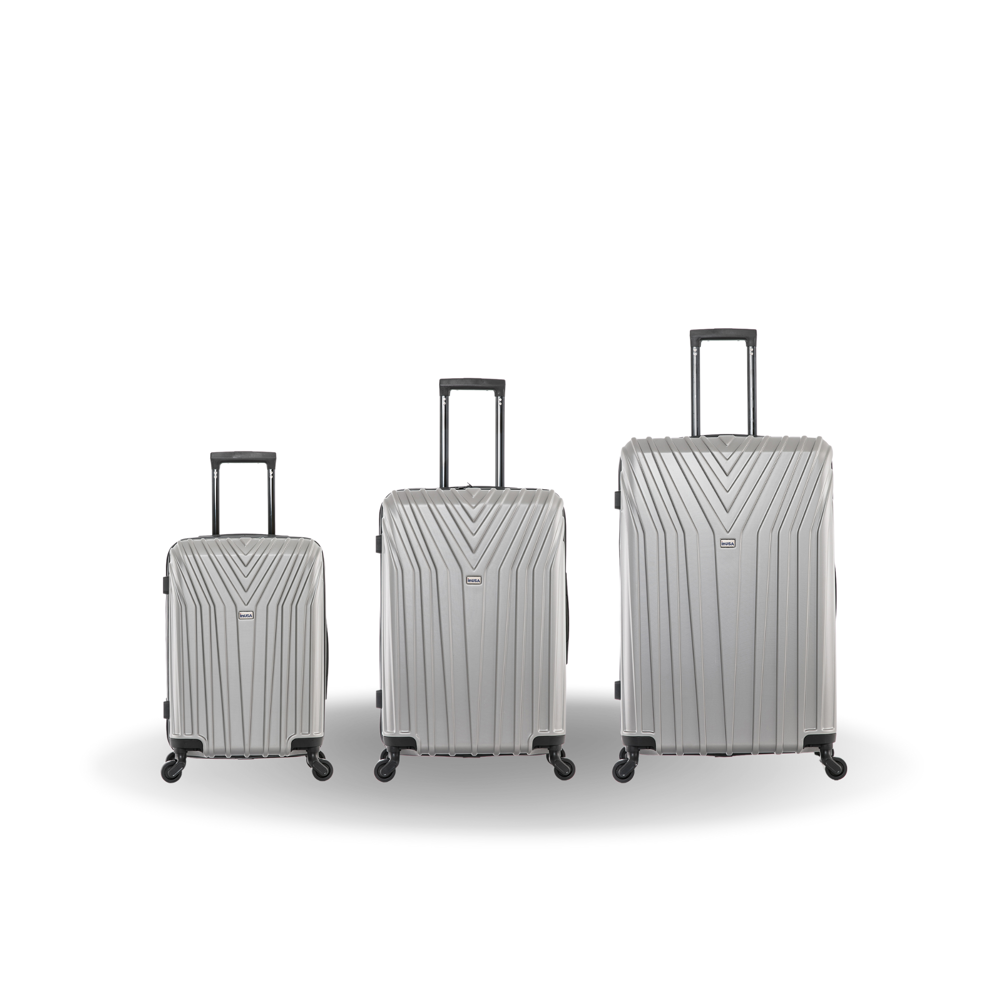 Three silver suitcases of different sizes on a white background