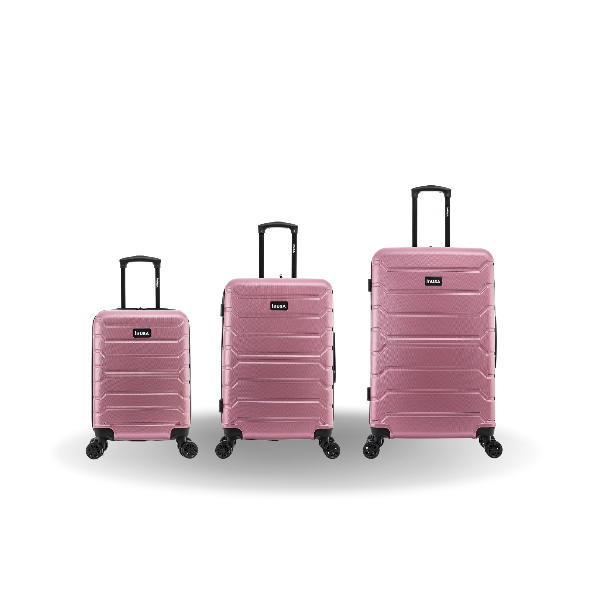 Three pink suitcases of different sizes on a white background