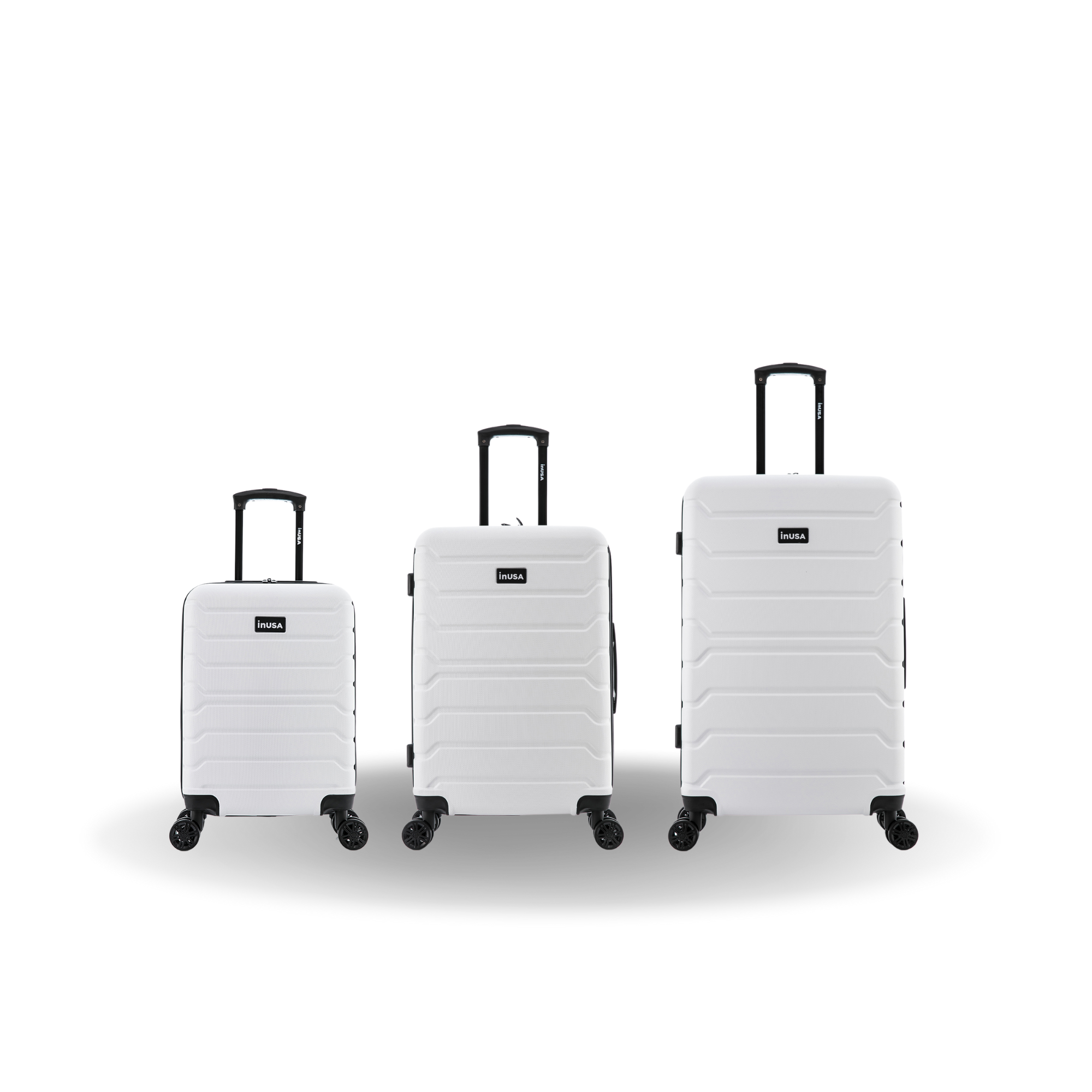 Three white suitcases of different sizes on a white background