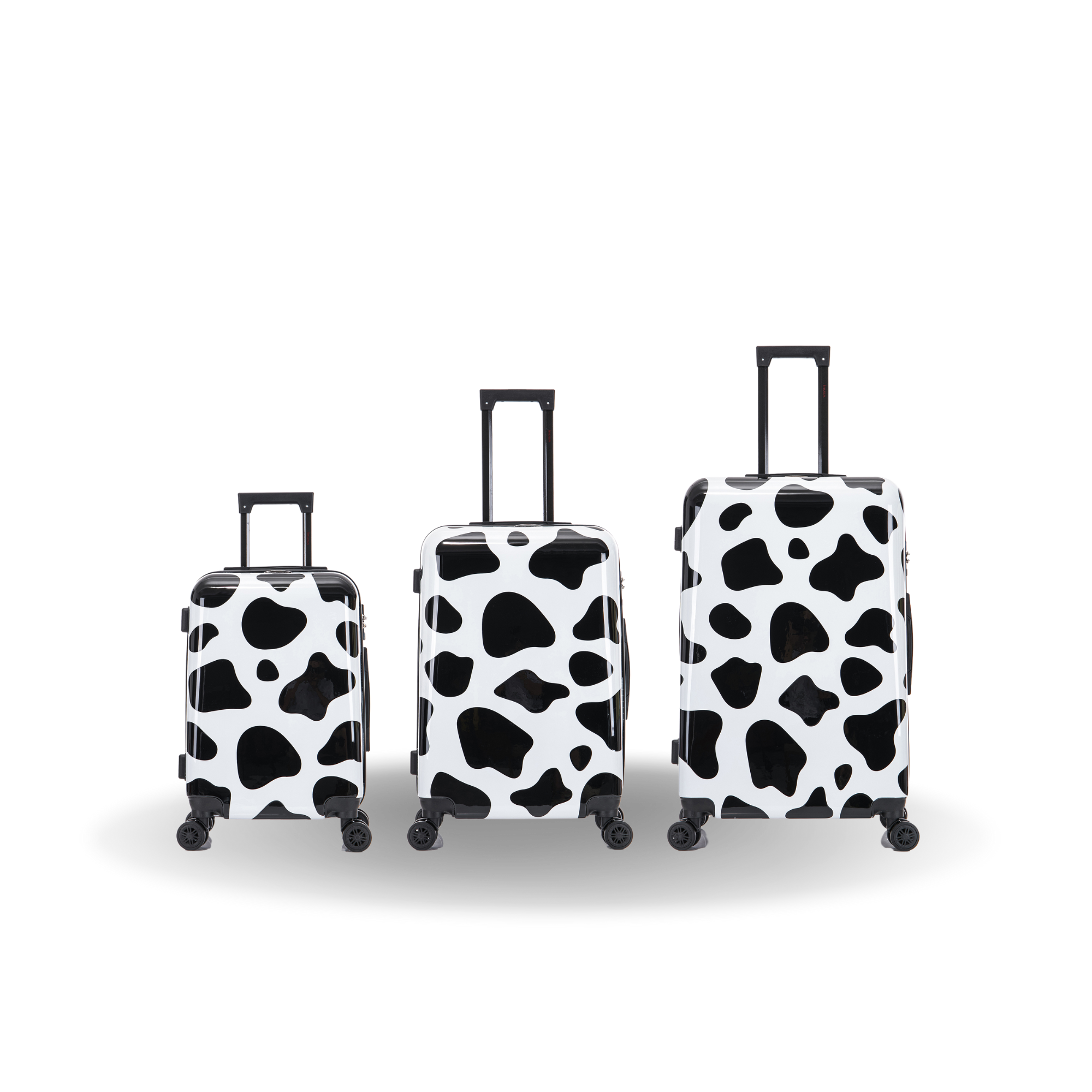 Three cow print suitcases of different sizes on a white background