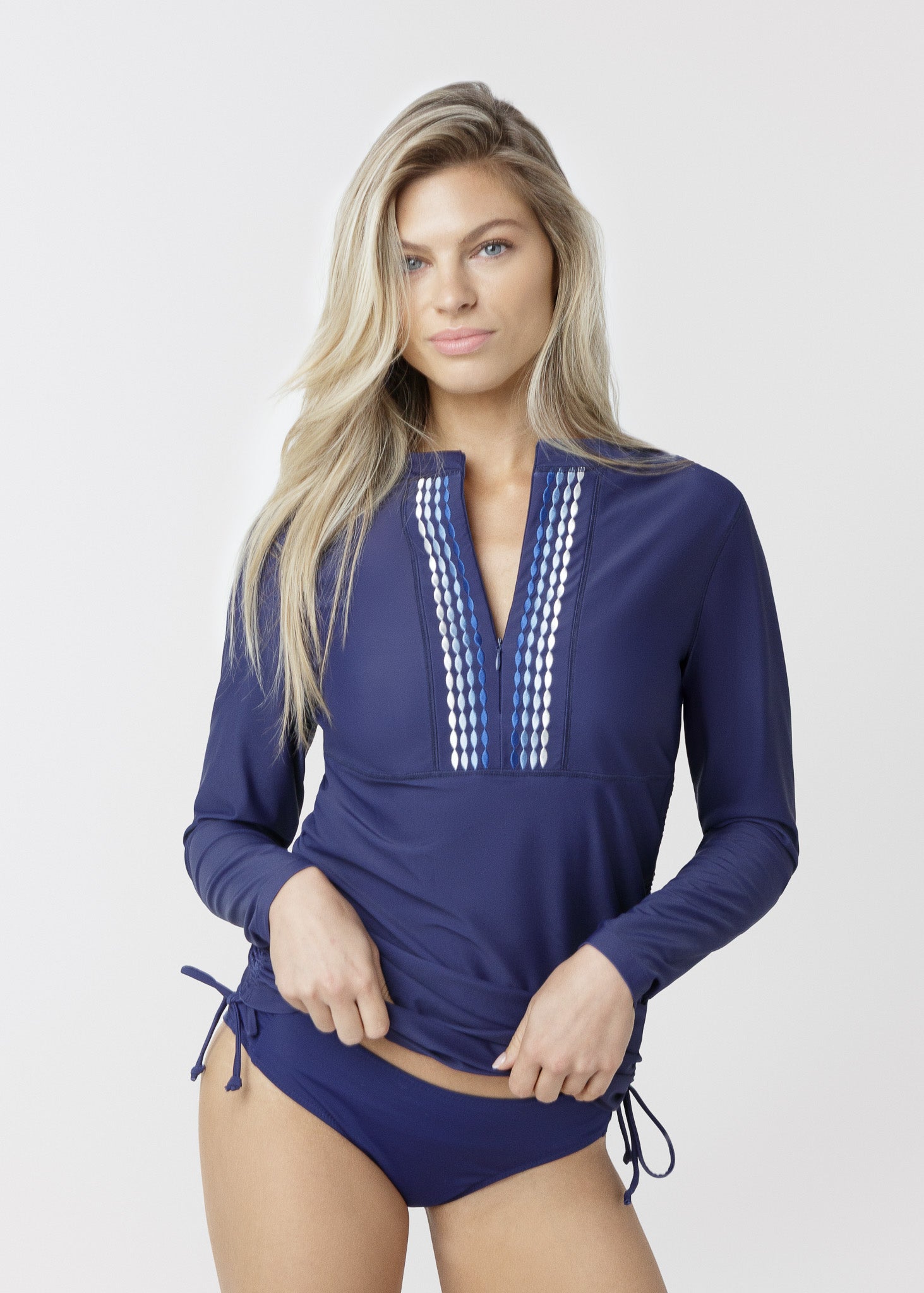 Woman wearing a blue swimsuit with long sleeves on a white background
