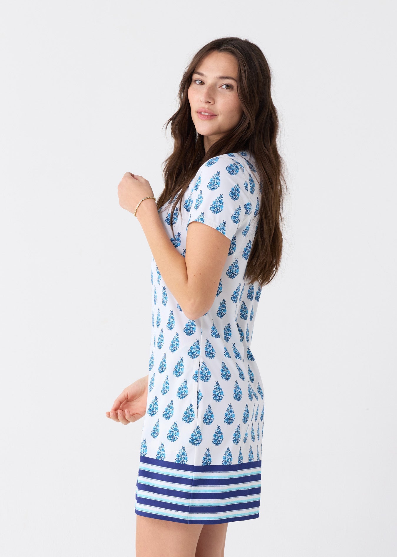 Woman wearing a blue and white patterned dress on a white background