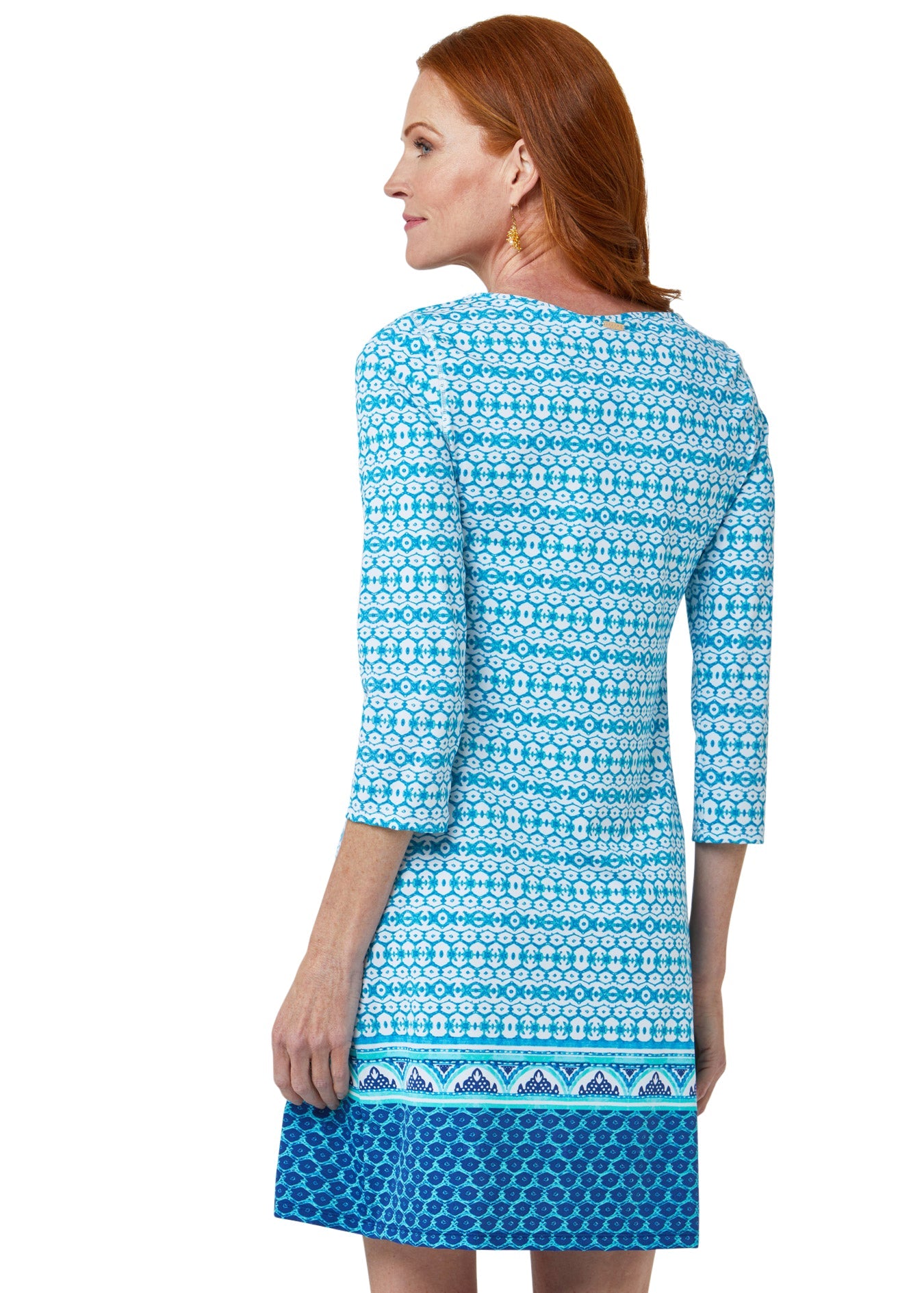 Woman wearing a blue patterned dress on a white background