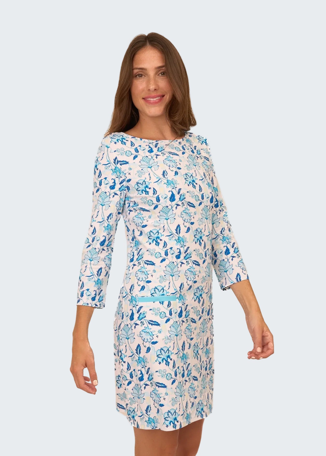 Woman wearing a floral dress with blue flowers on a white background