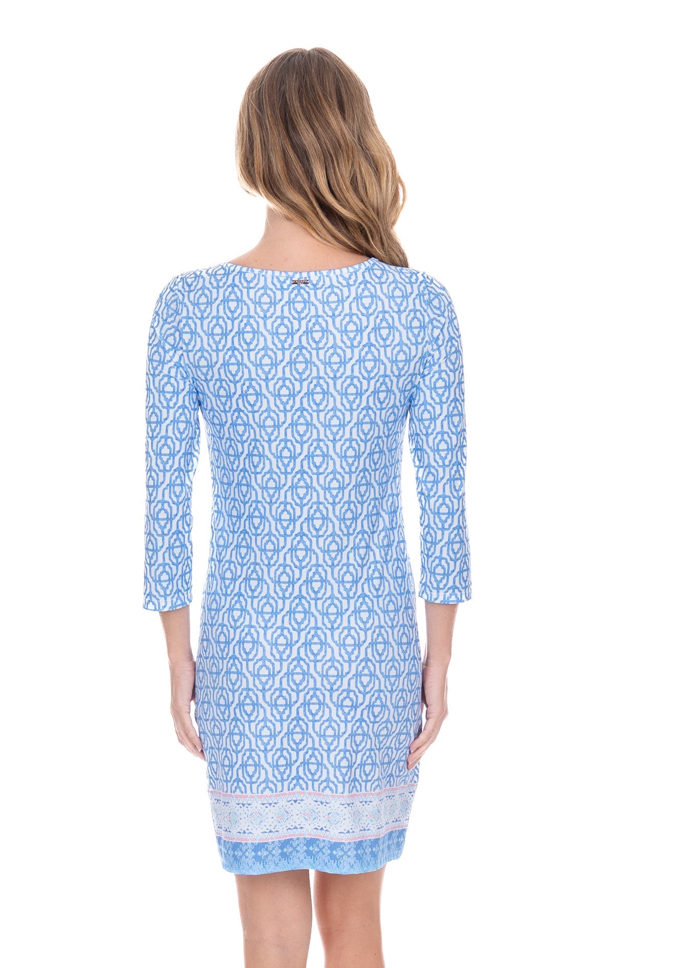 Woman wearing a blue patterned dress on a white background