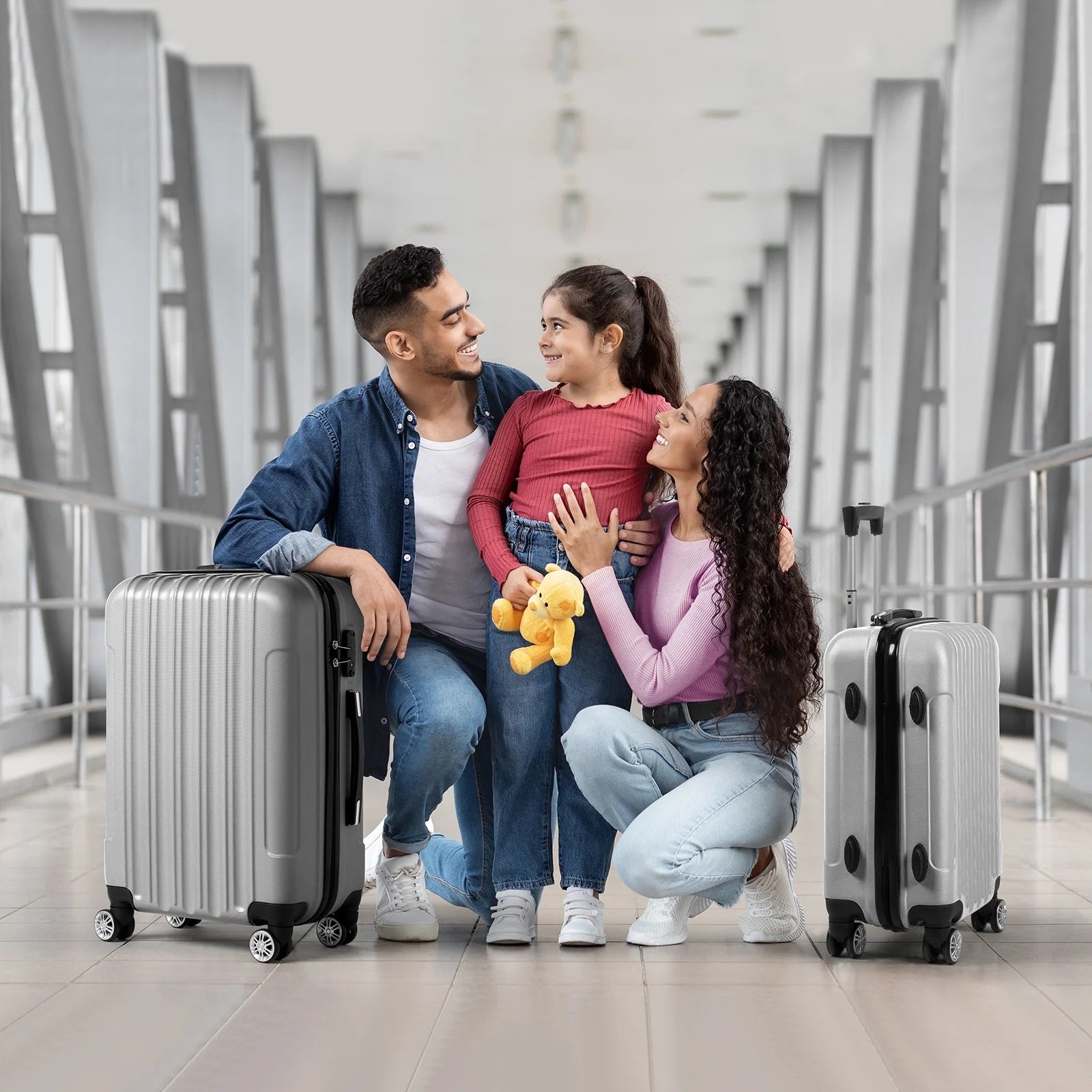 Family with a child in an airport with suitcases