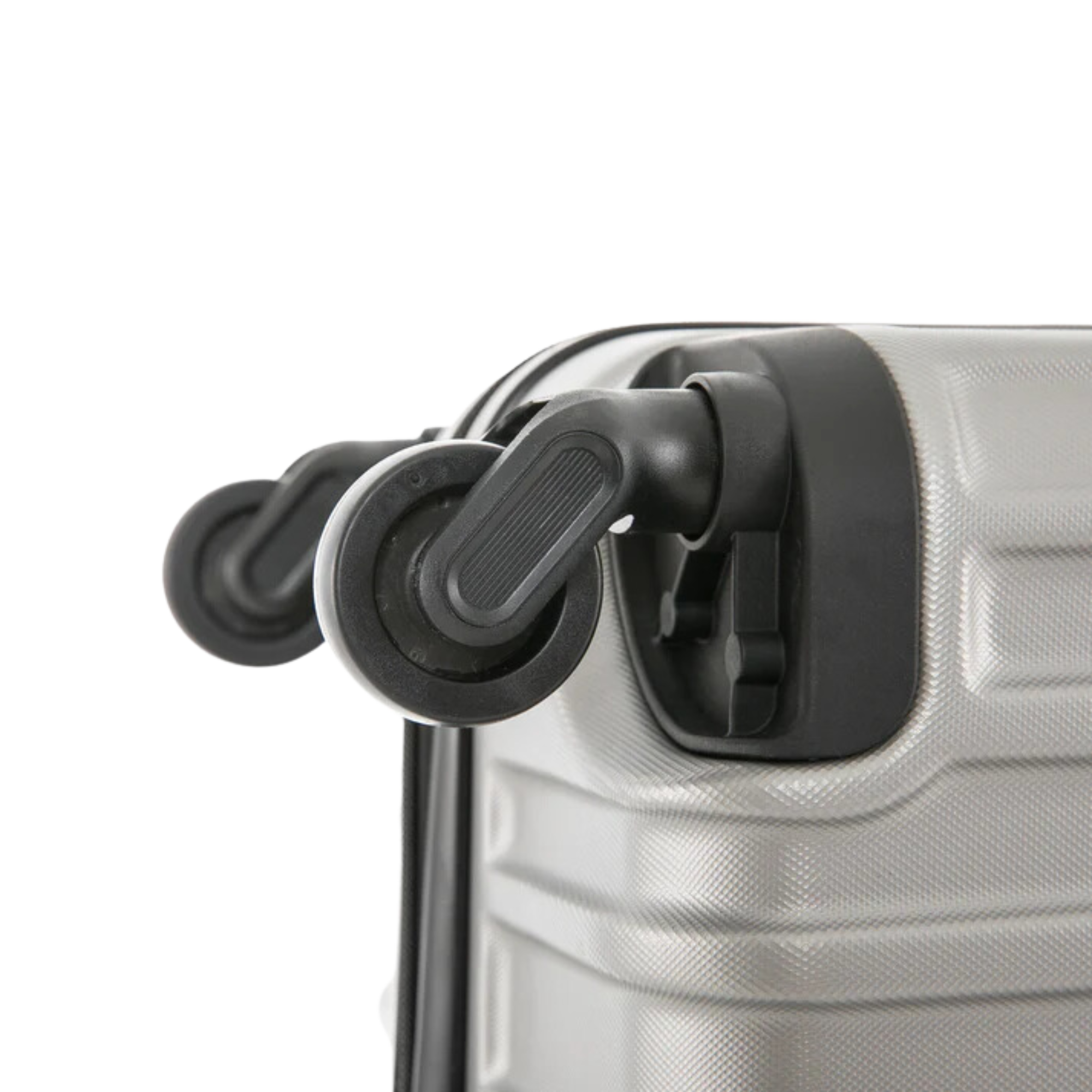Close-up of a silver suitcase with black wheels on a white background