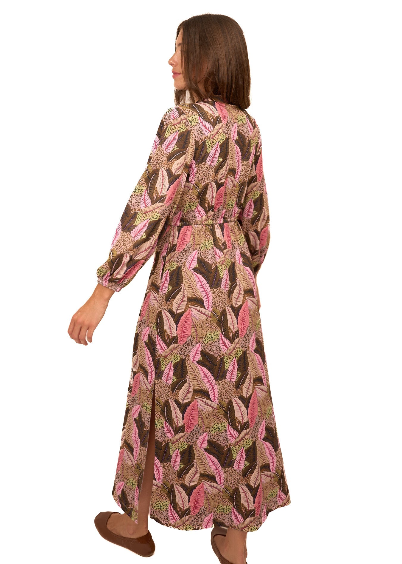 Woman wearing a patterned dress on a white background