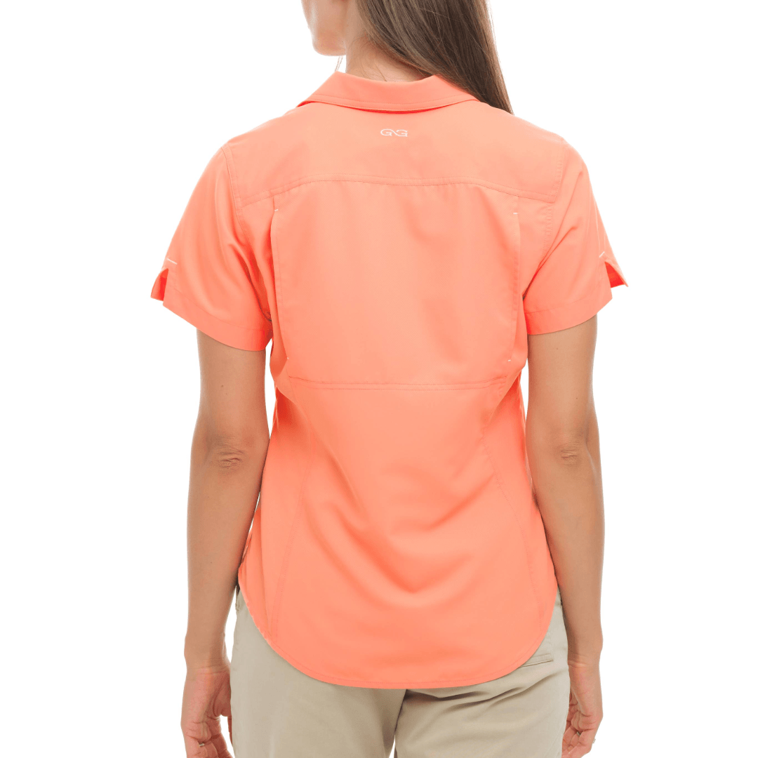 Person wearing a coral-colored shirt on a white background