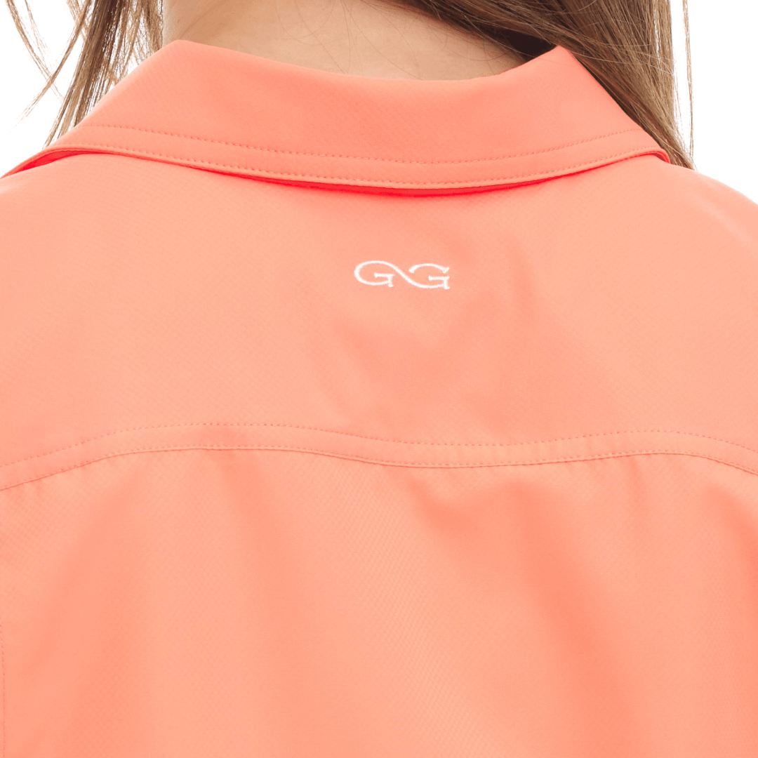 Close-up of a peach-colored jacket with a logo on the collar.