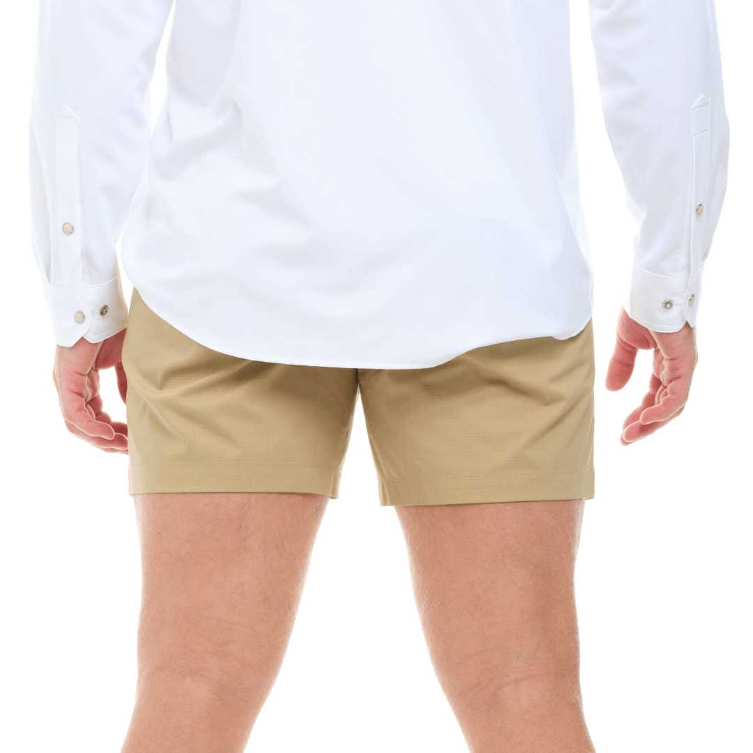 Person wearing a white shirt and beige shorts on a white background