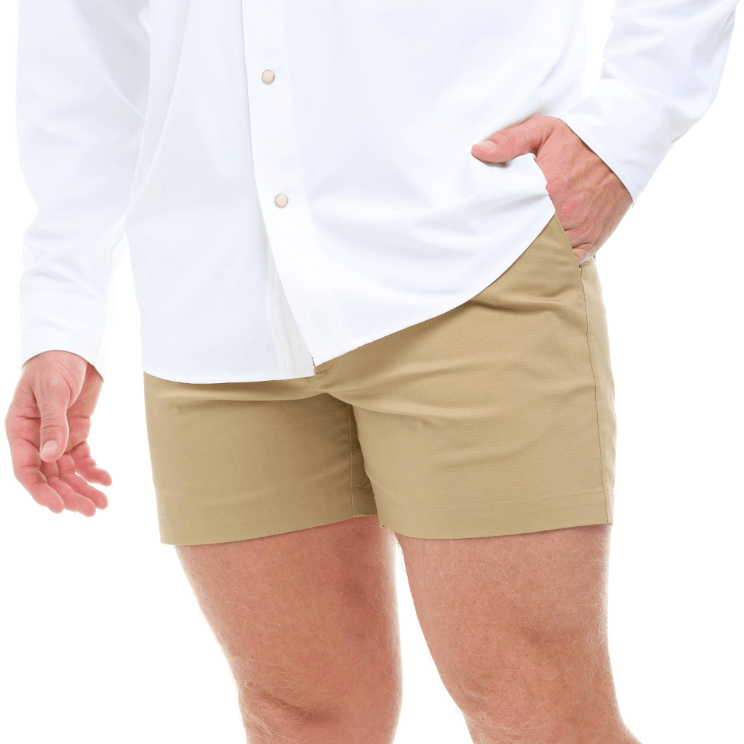Person wearing beige shorts and a white shirt on a white background