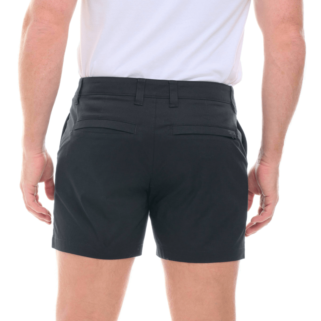 Person wearing black shorts on a white background