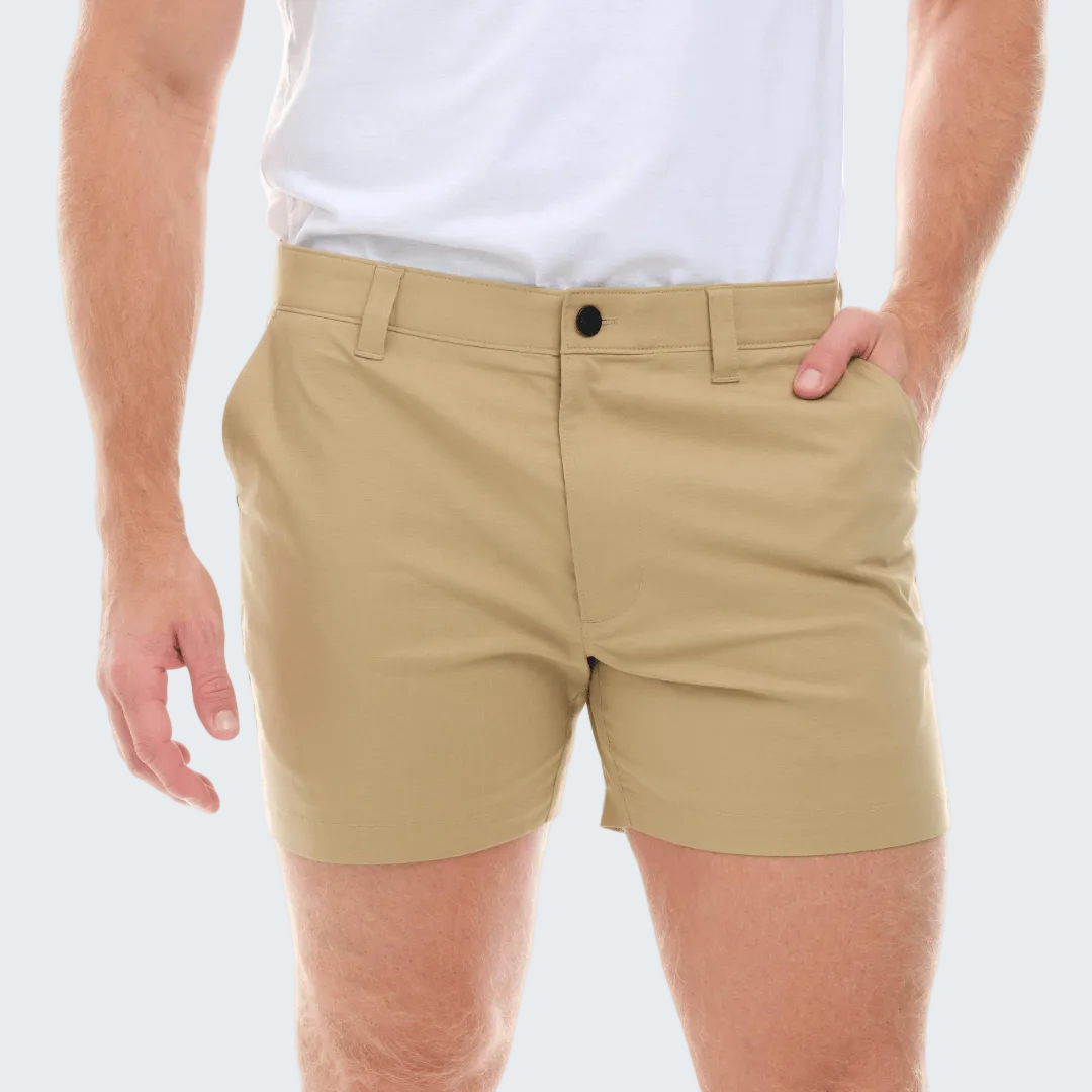 Beige shorts worn by a person on a white background