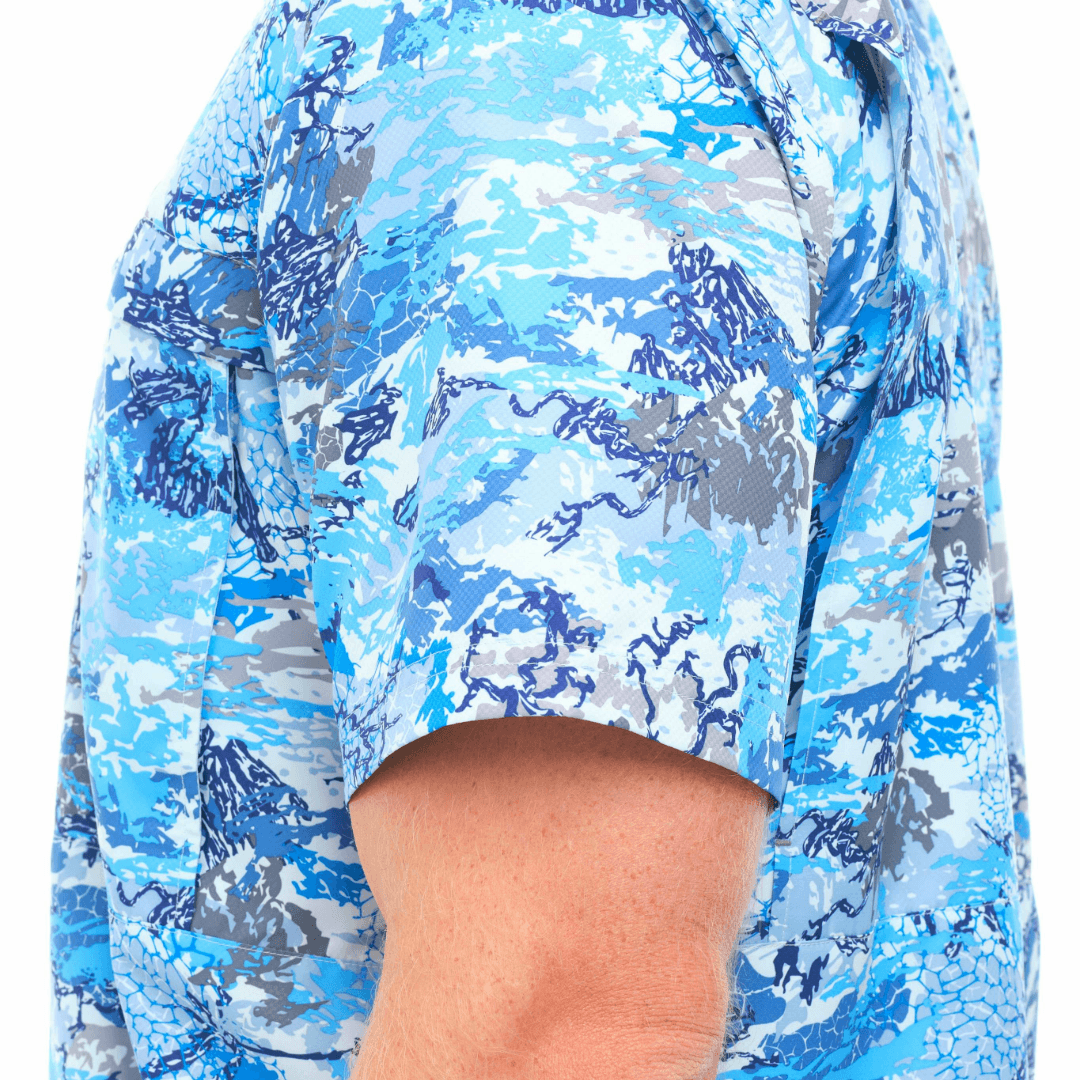 Close-up of a person wearing a blue camouflage shirt on a white background