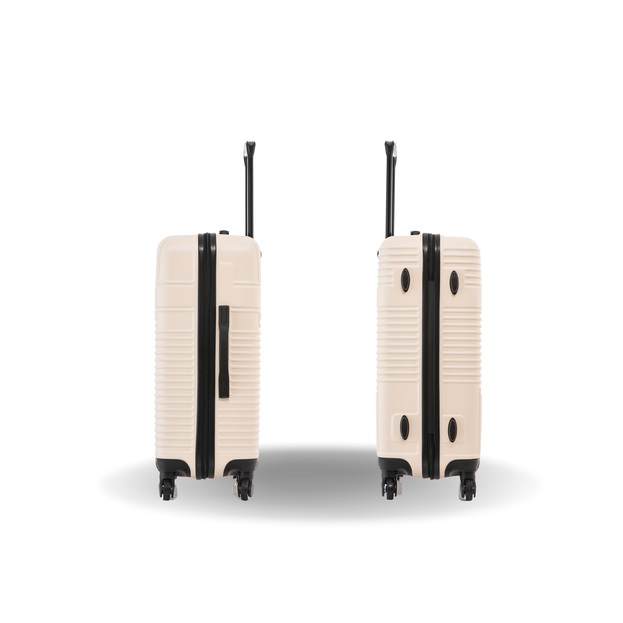 Two beige suitcases with black accents on a white background