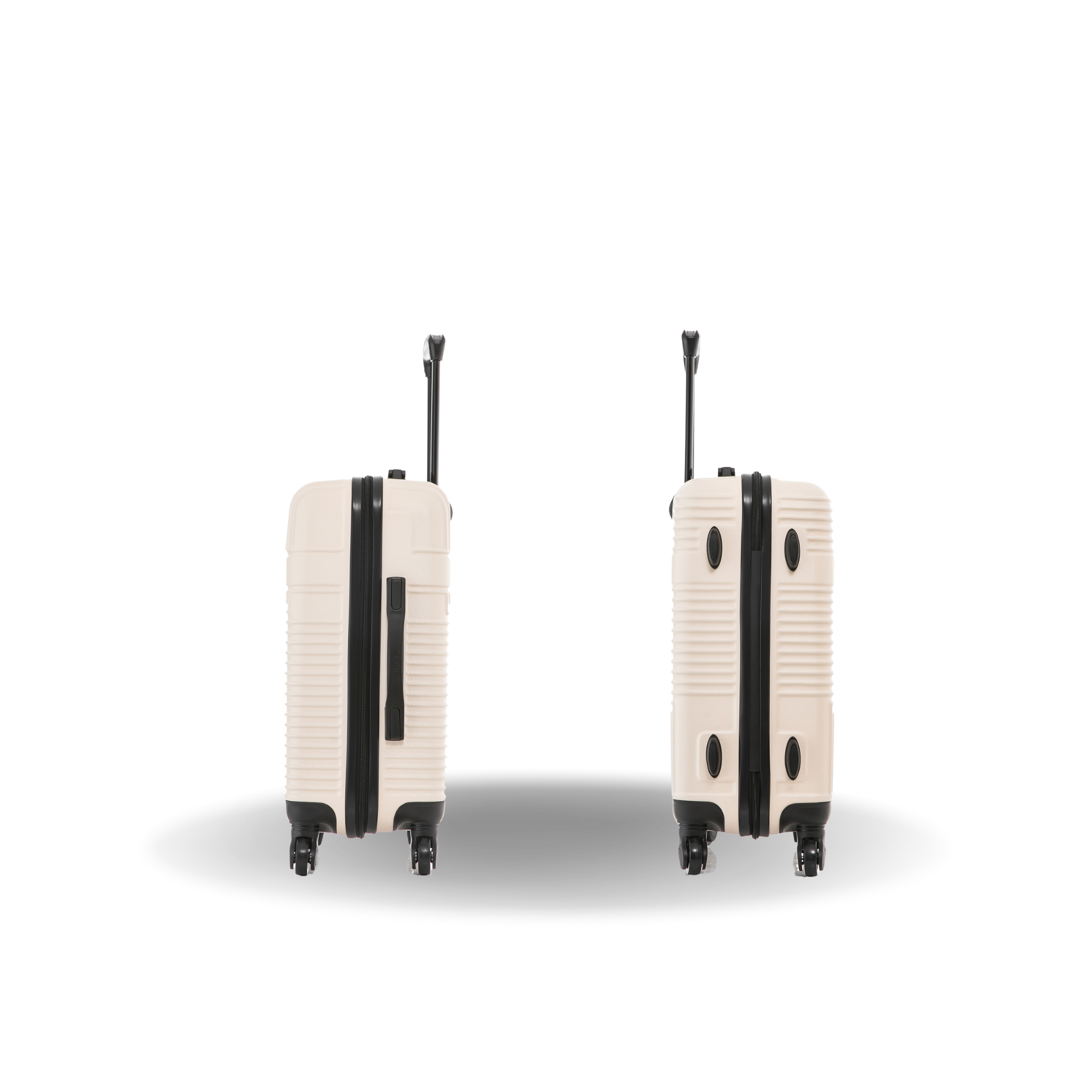 Two beige suitcases with black accents on a white background