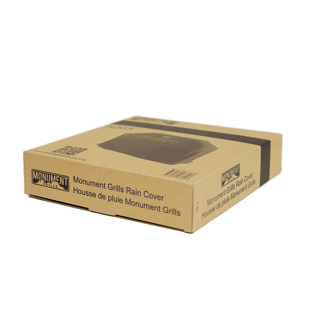 Cardboard box packaging for Monument Grills rain cover on a white background