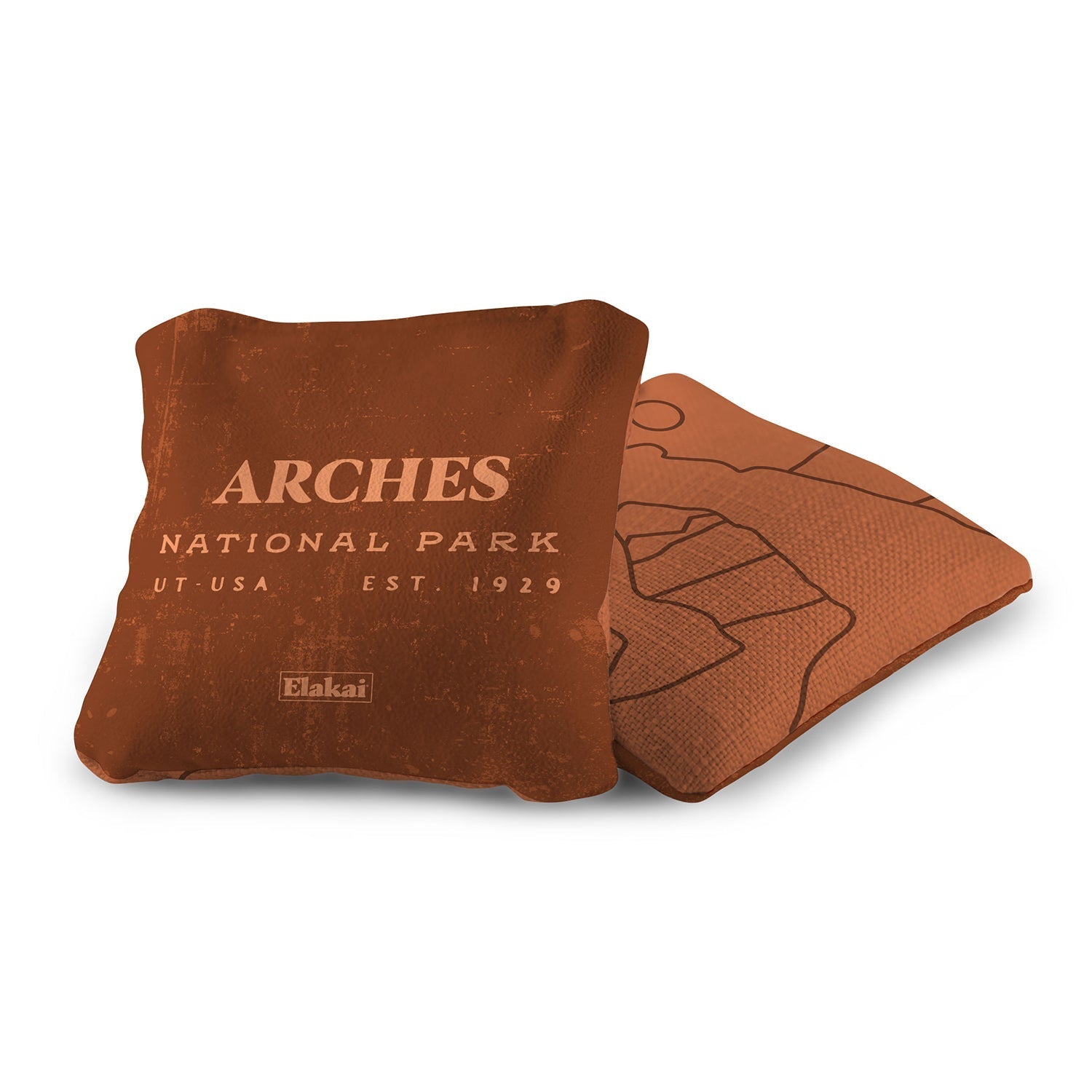 Brown pillow with 'Arches National Park' text on a white background