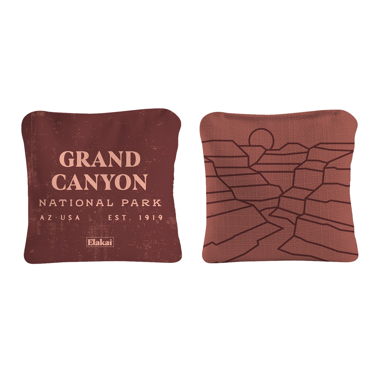 Two brown pillows with Grand Canyon National Park text and map design on a white background