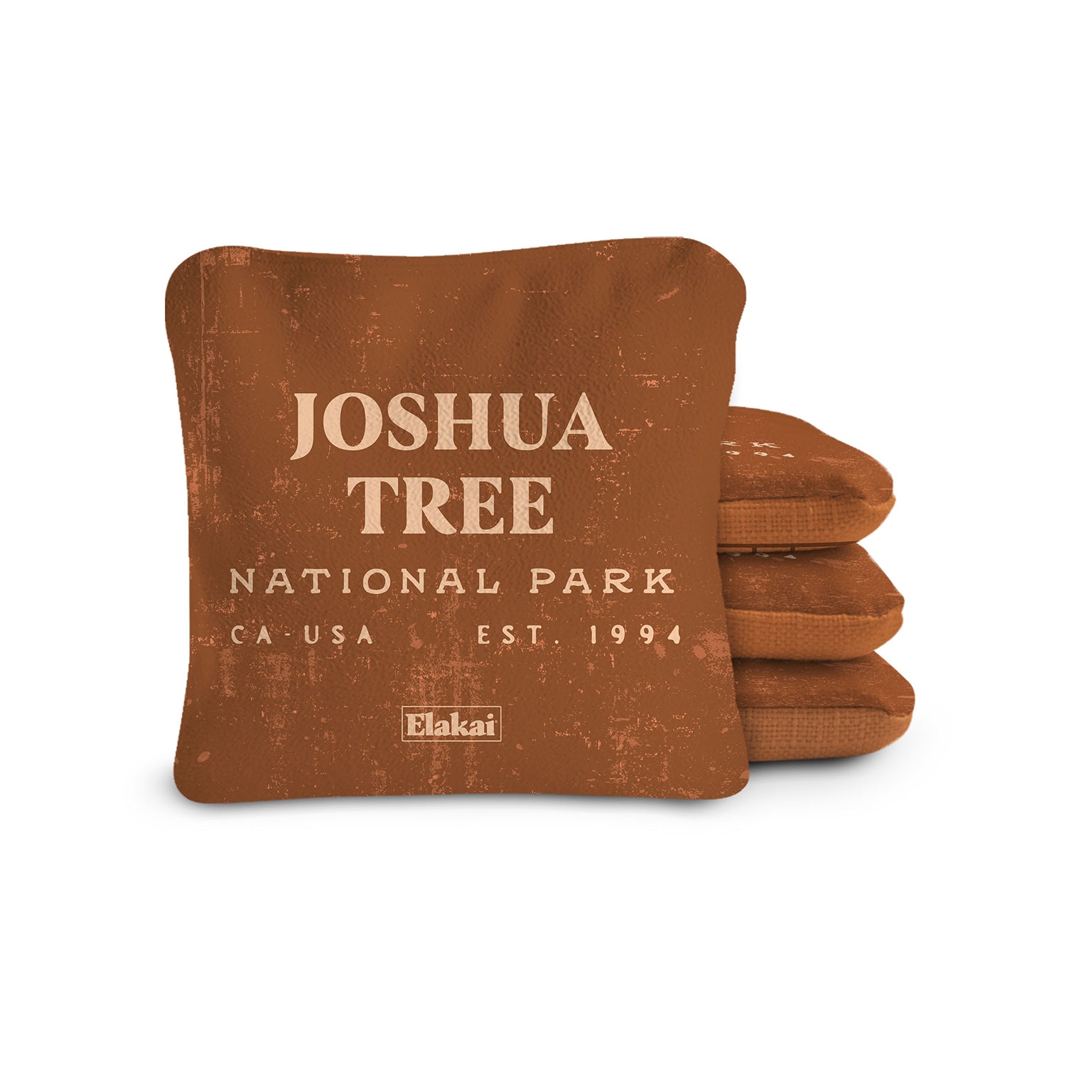 Brown pillow with 'Joshua Tree National Park' text on a white background
