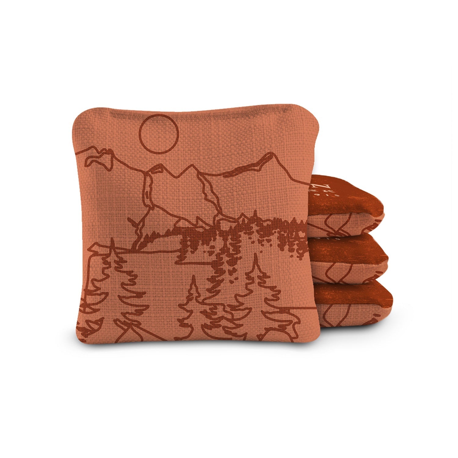 Set of three brown coasters with mountain and lake design on a white background