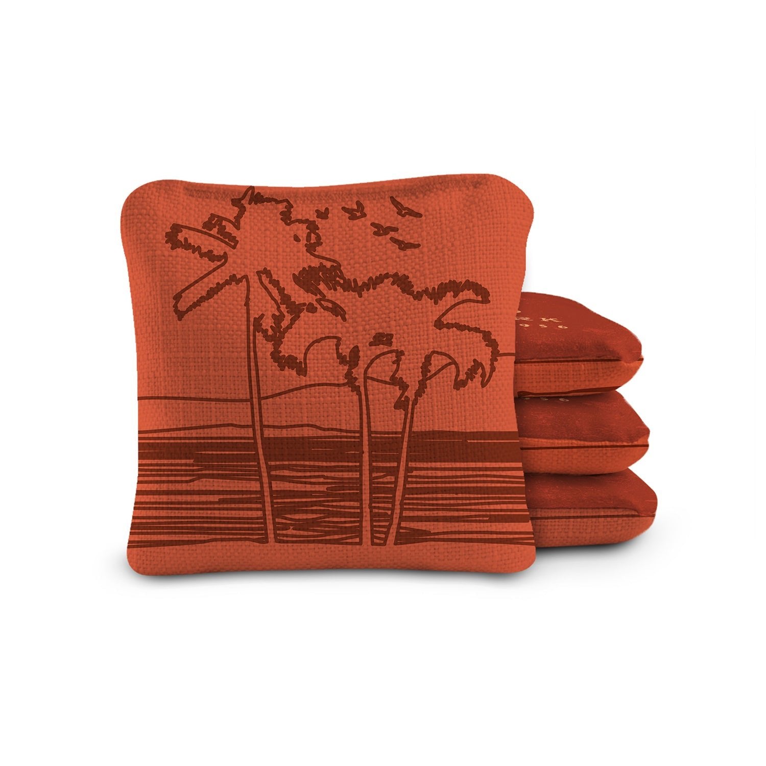 Stack of red cushions with palm tree design on a white background