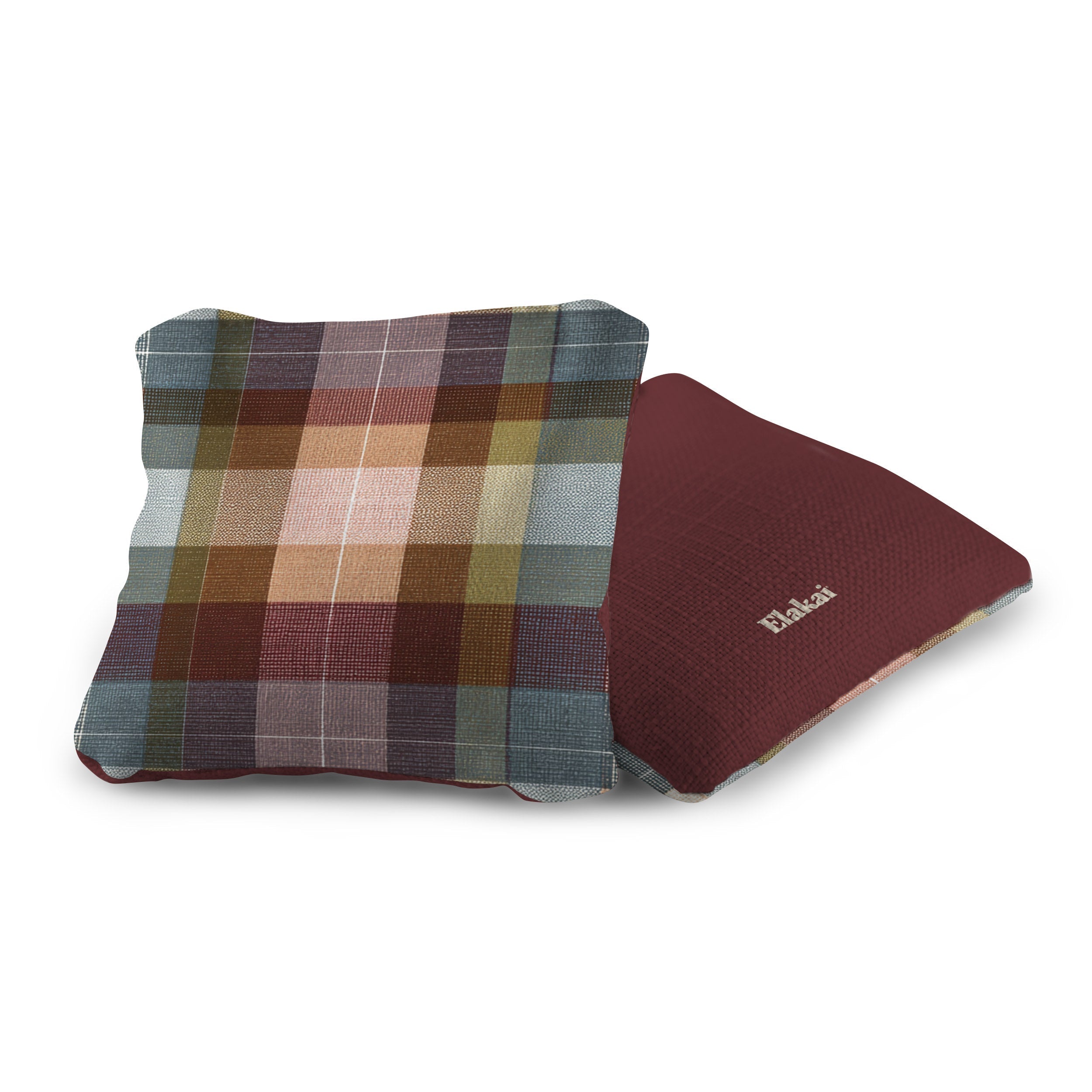 Two pillows, one plaid and one solid maroon, on a white background