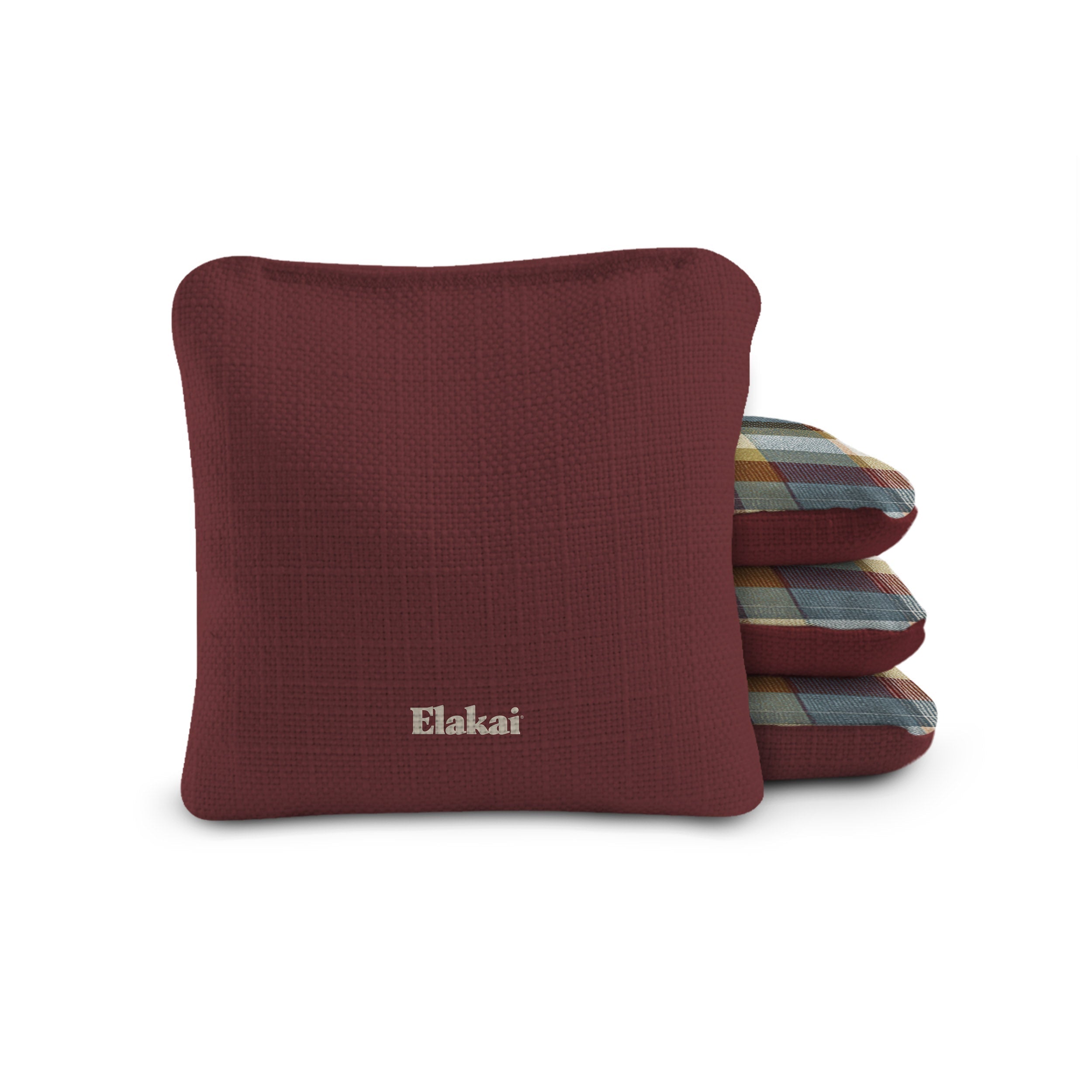 Maroon pillow with 'Elakai' branding on a white background