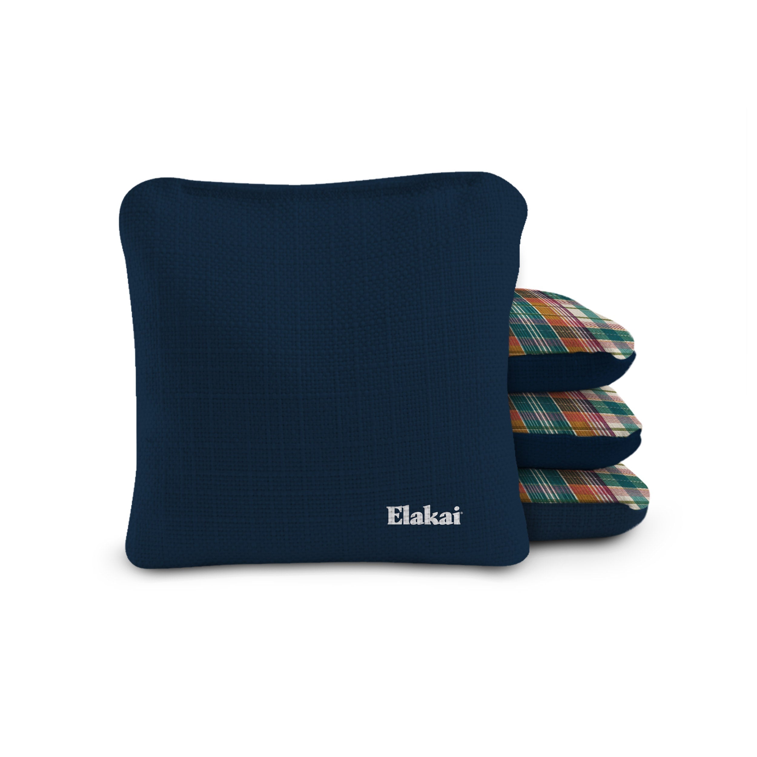 Navy blue pillow with plaid patterned pillows stacked behind on a white background, featuring the brand 'Elakai'.