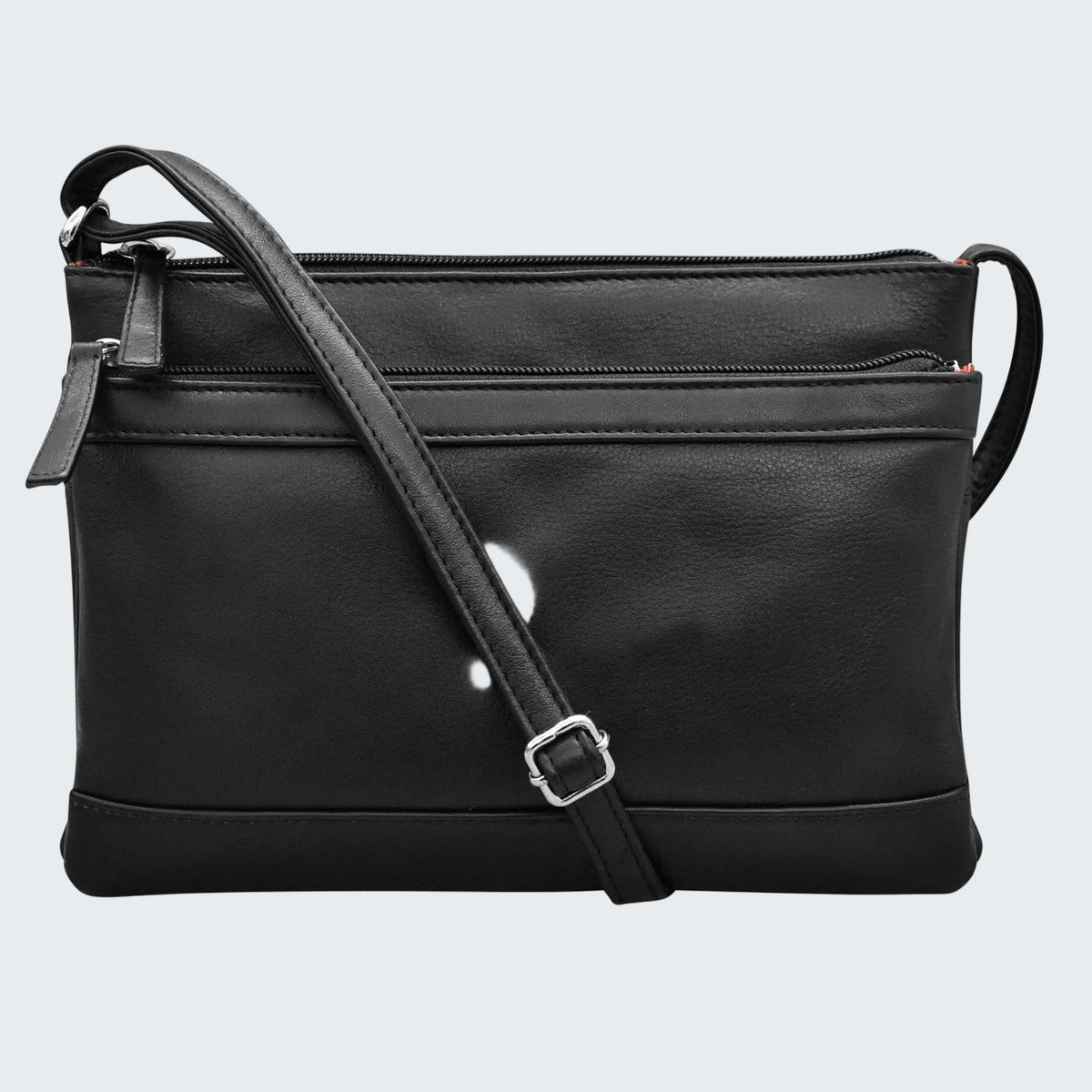Black faux-leather crossbody bag with a top zipper, front slip pocket, and adjustable shoulder strap with a silver buckle, shown on a plain white background.