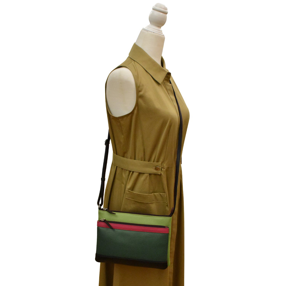 Mannequin wearing a tan vest with a green and pink bag attached.