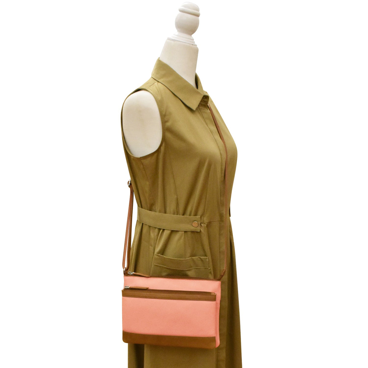 Green sleeveless dress with a pink and brown handbag on a mannequin against a white background