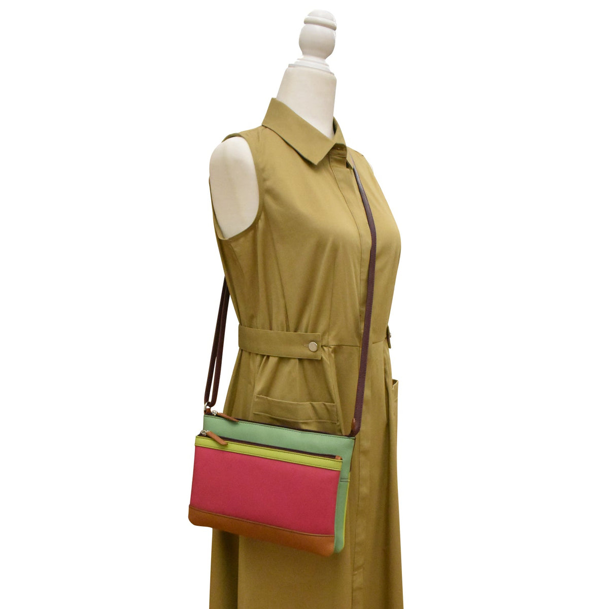 Green dress with a colorful handbag on a mannequin against a white background