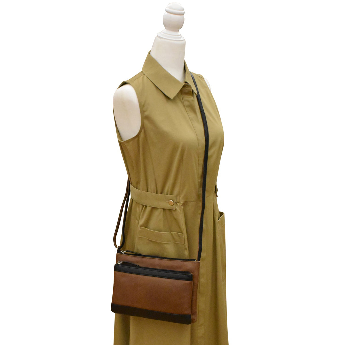 Mannequin wearing a beige trench coat with a brown leather bag on a white background