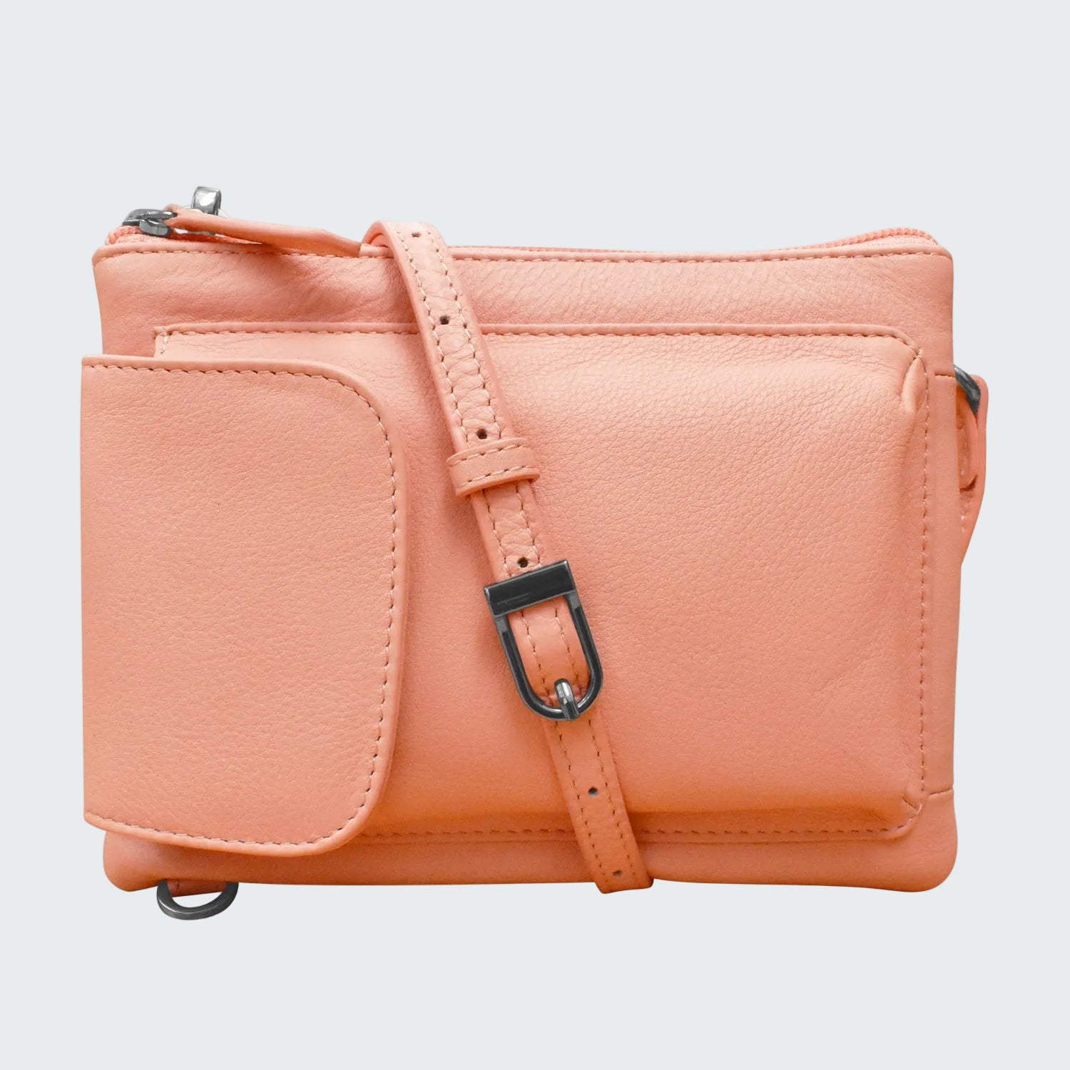 Pink leather crossbody bag with strap on a white background