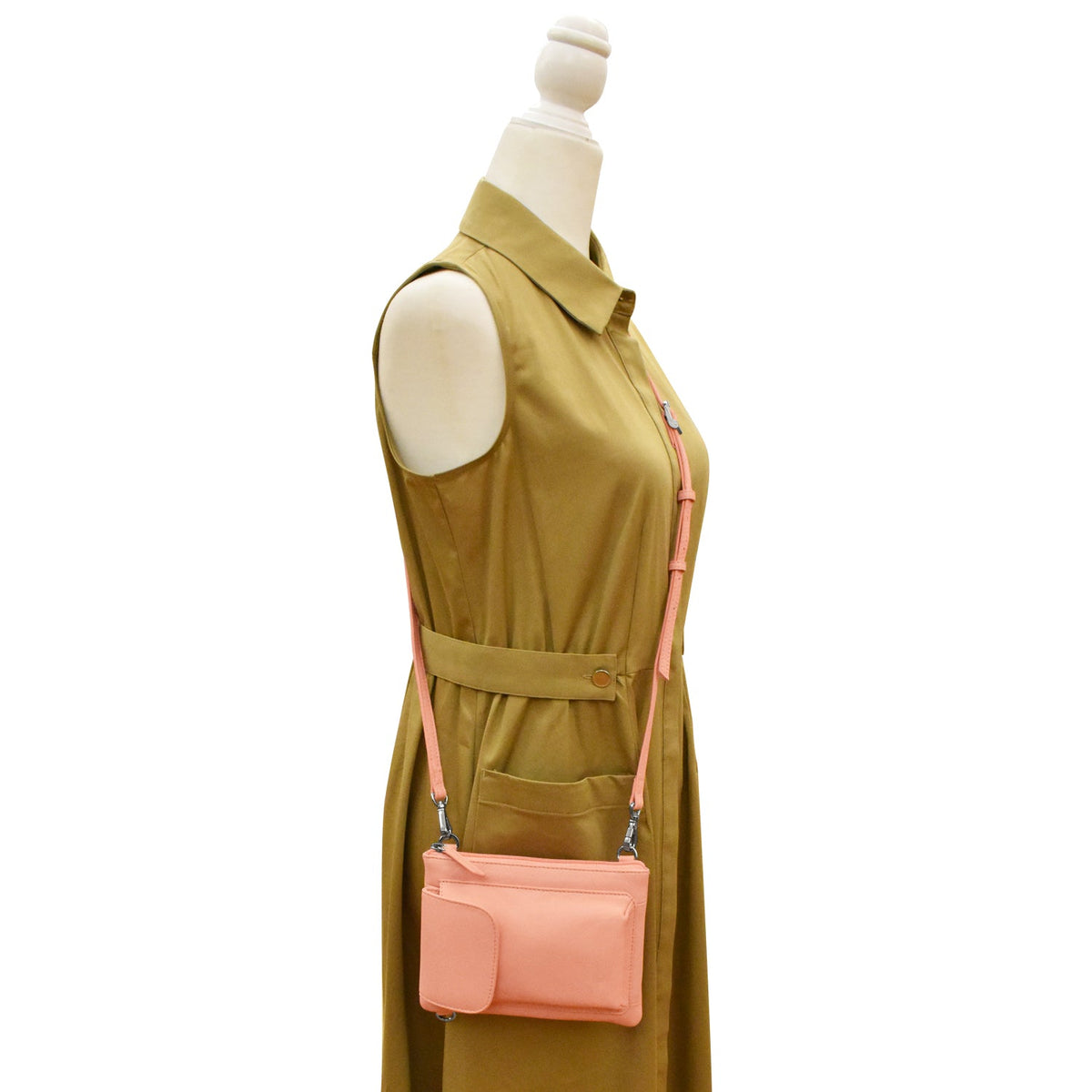 peach purse on green dress mannequin