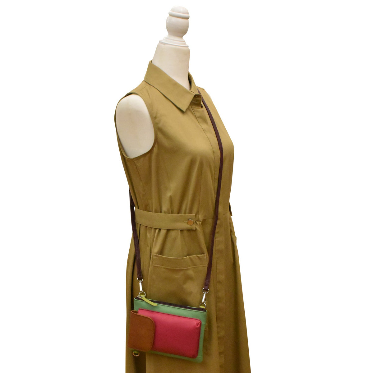 Mannequin wearing a beige dress with colorful patch pockets on a white background