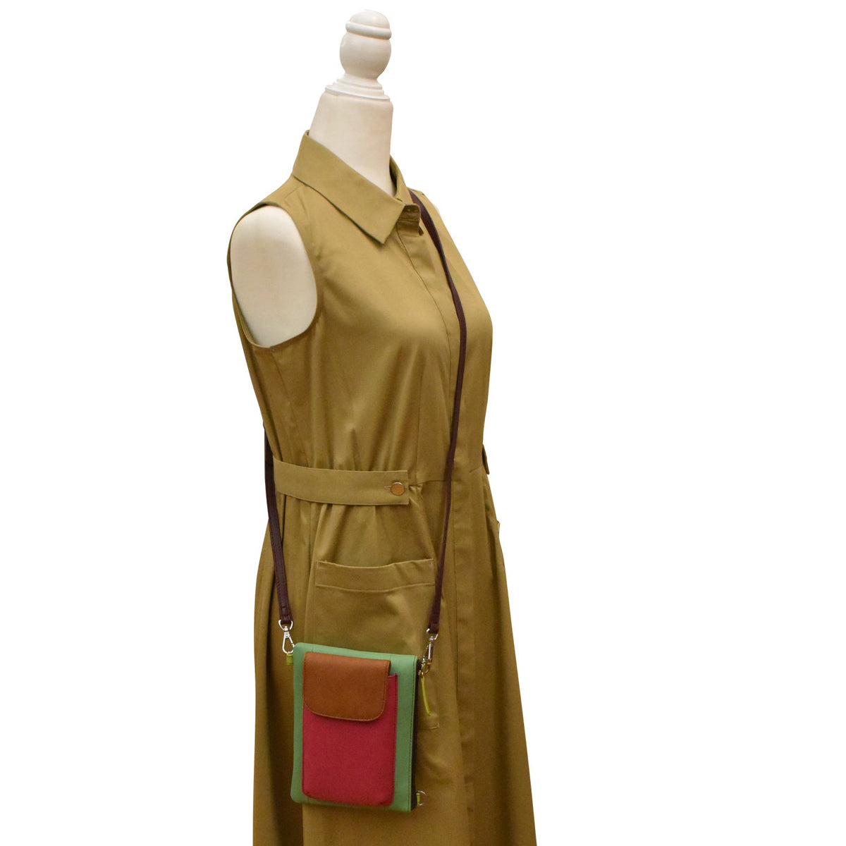 Mannequin wearing a beige dress with a green and red pocket on a white background