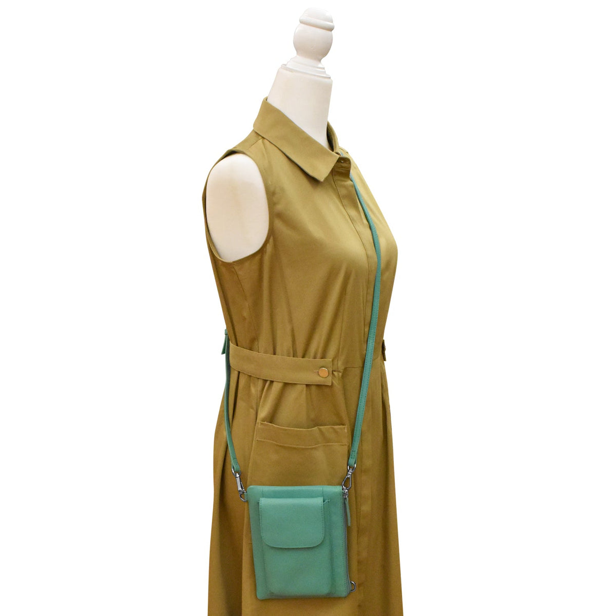 Mannequin wearing a mustard yellow dress with a turquoise crossbody bag on a white background