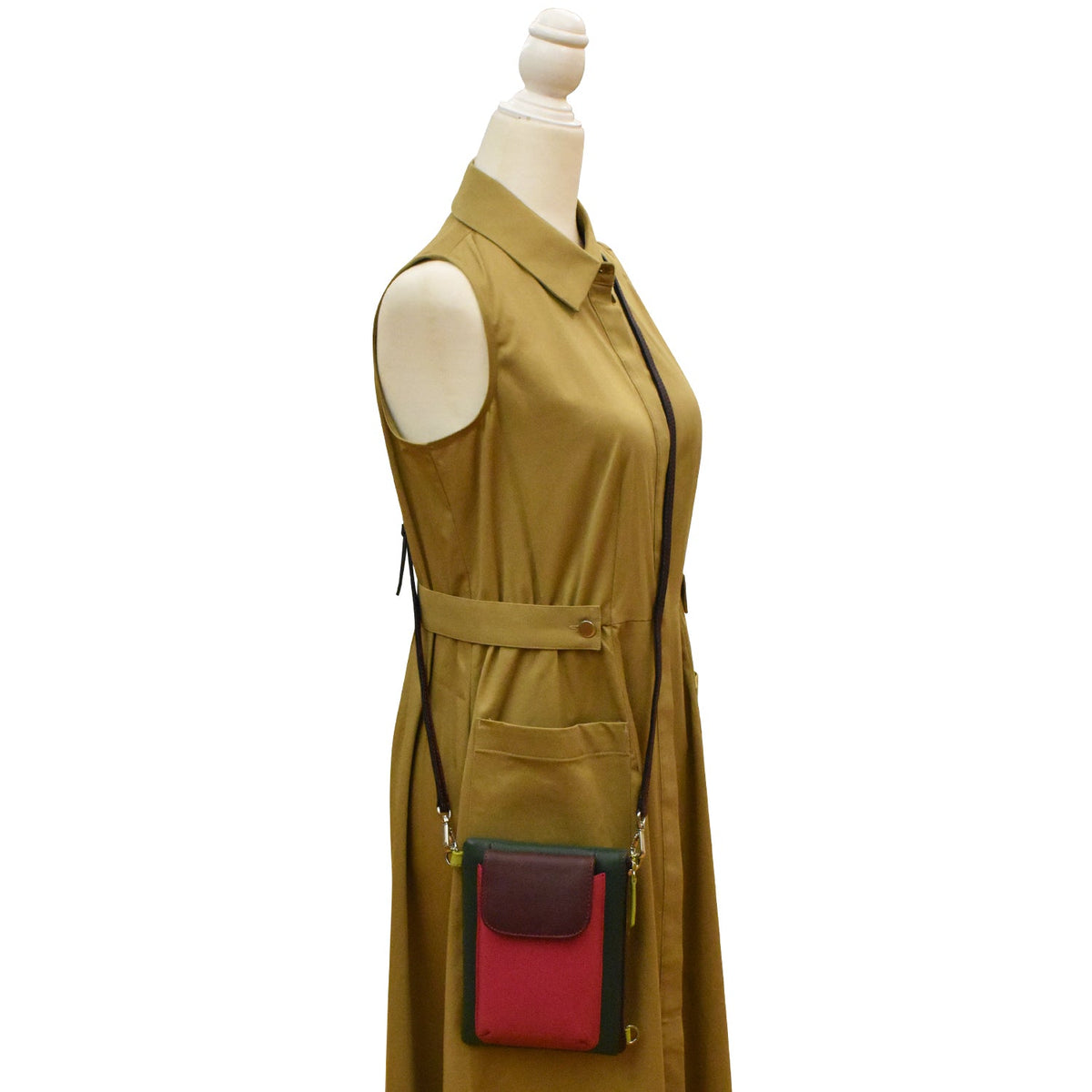 Mannequin wearing a mustard yellow dress with a red and black pocket on a white background