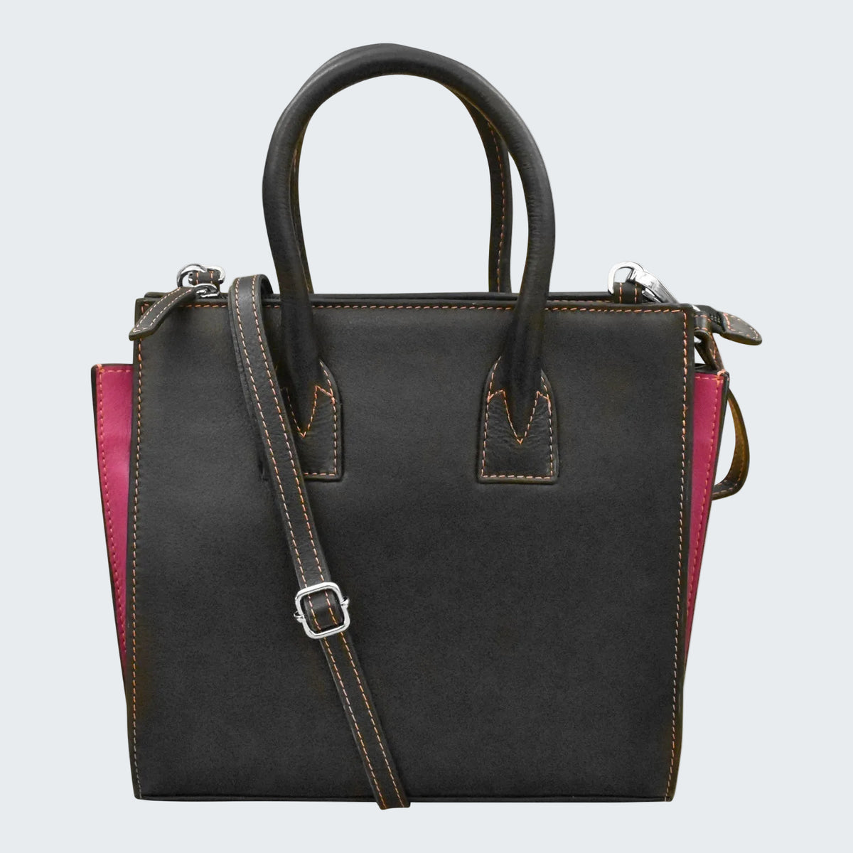 Black leather handbag with pink interior on a white background