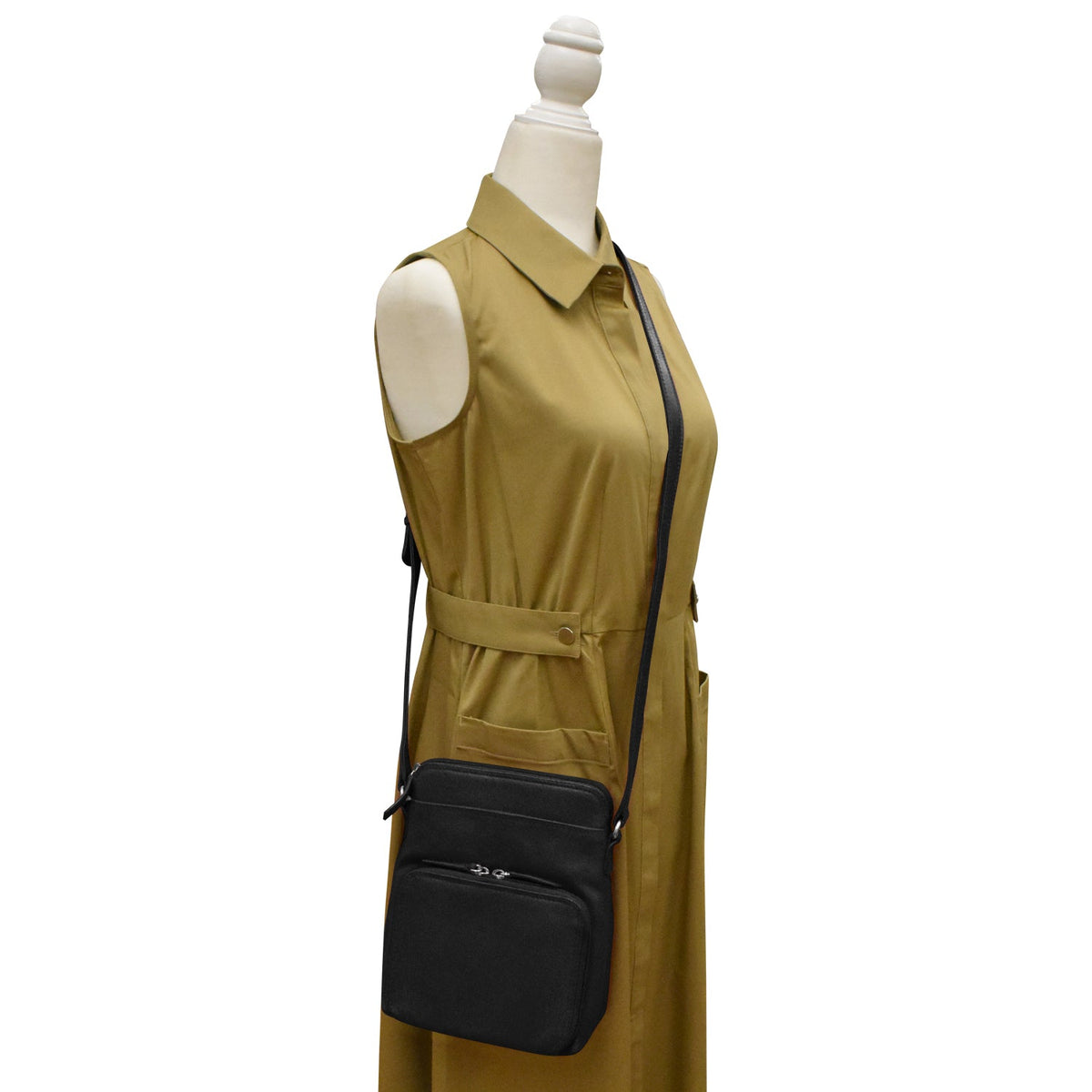 Mannequin wearing a mustard yellow dress with a black handbag on a white background