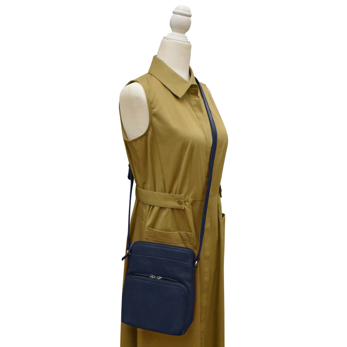 Mannequin wearing a mustard yellow dress with a navy blue crossbody bag on a white background