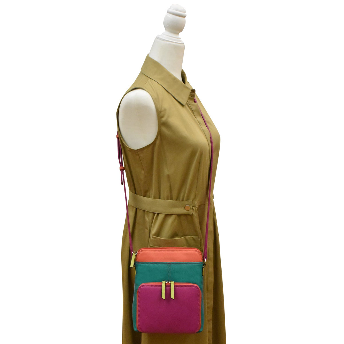 Mannequin wearing a beige dress with a colorful bag on a white background