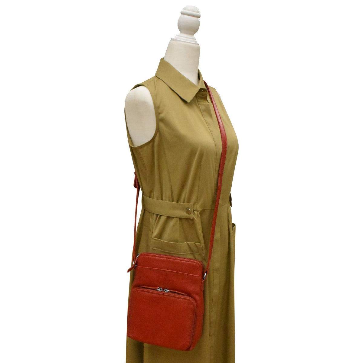Mannequin wearing a beige dress with a red crossbody bag on a white background
