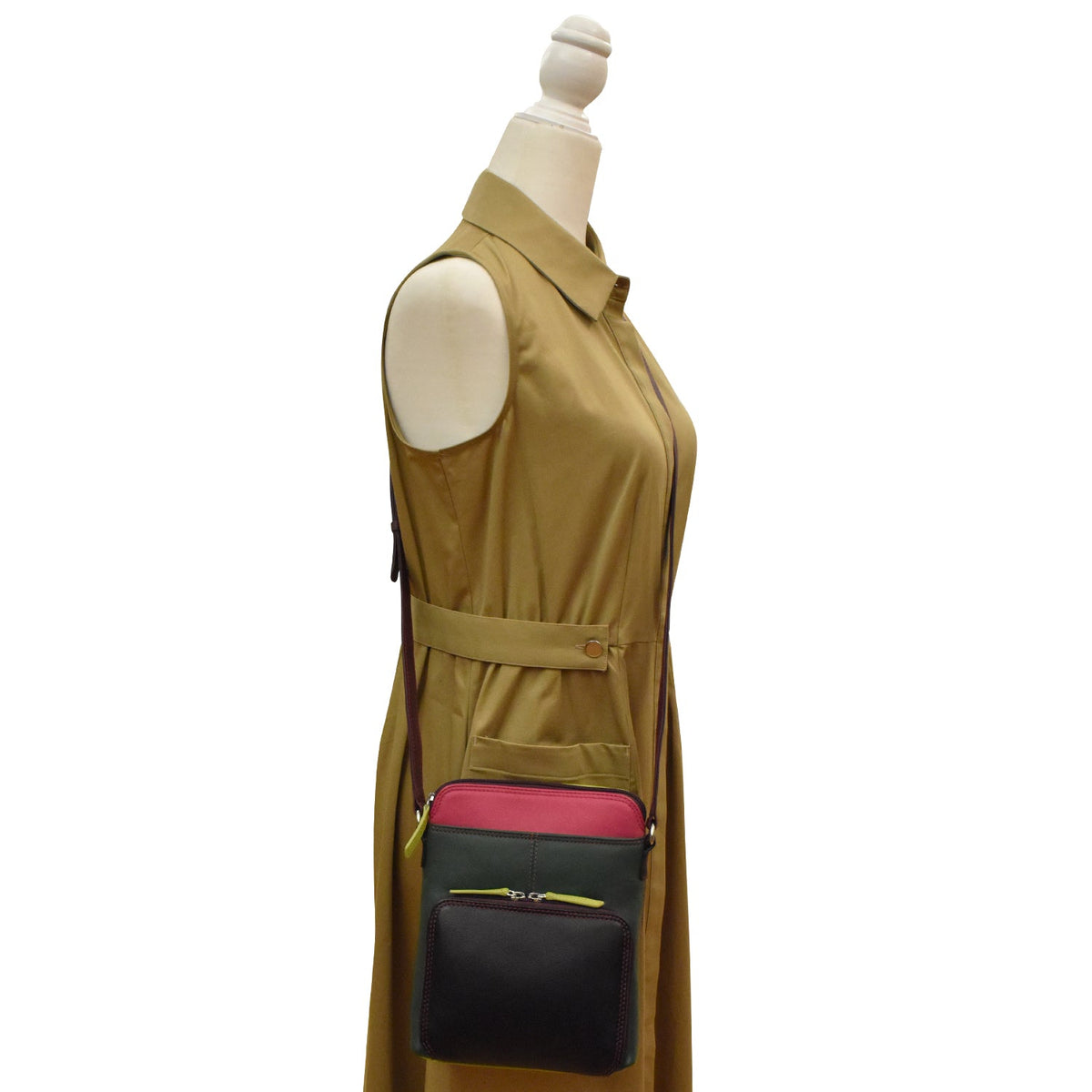 Mannequin wearing a brown dress with a black and pink handbag on a white background